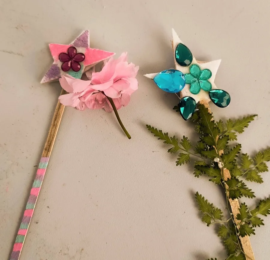 Fabric flowers and jewels arranged on a table, ready to be made into wands